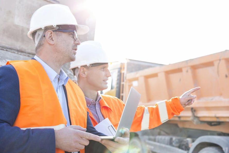 Image of two men conducting Construction Quality Management for contractors